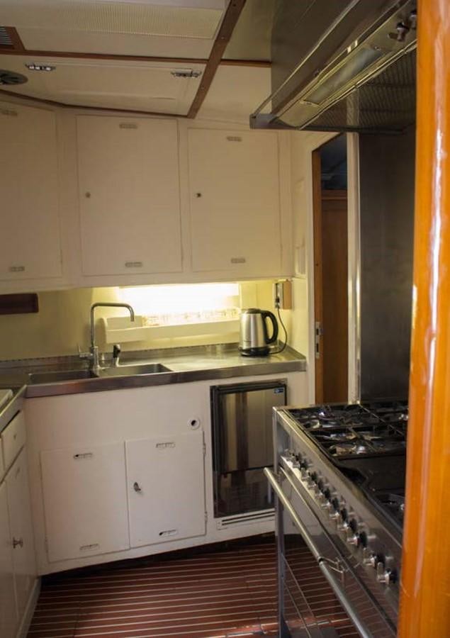 a kitchen with white cabinets aboard FEI-SEEN Yacht for Sale