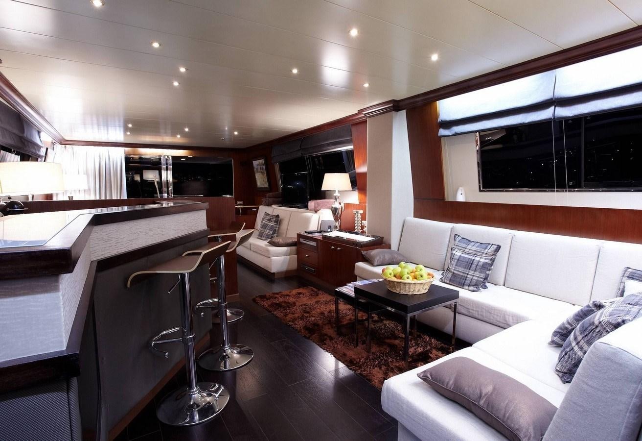 a living room with a couch and a coffee table aboard QUEEN SOUTH Yacht for Charter