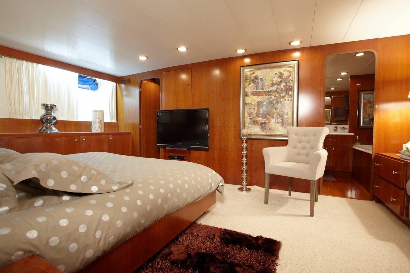 a bedroom with a bed and a tv aboard QUEEN SOUTH Yacht for Charter