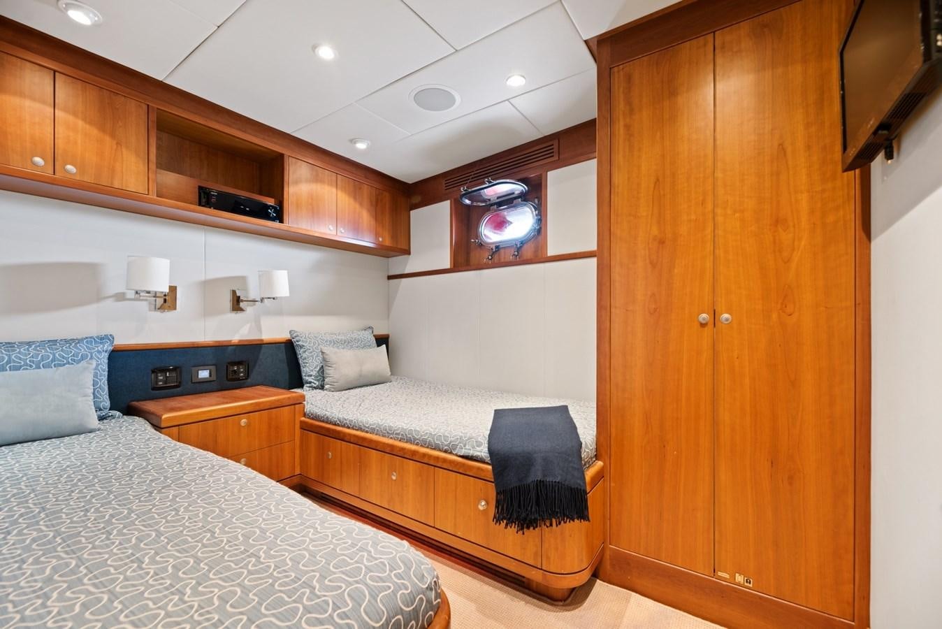 a bedroom with a bed and a desk aboard A.B. NORMAL Yacht for Sale
