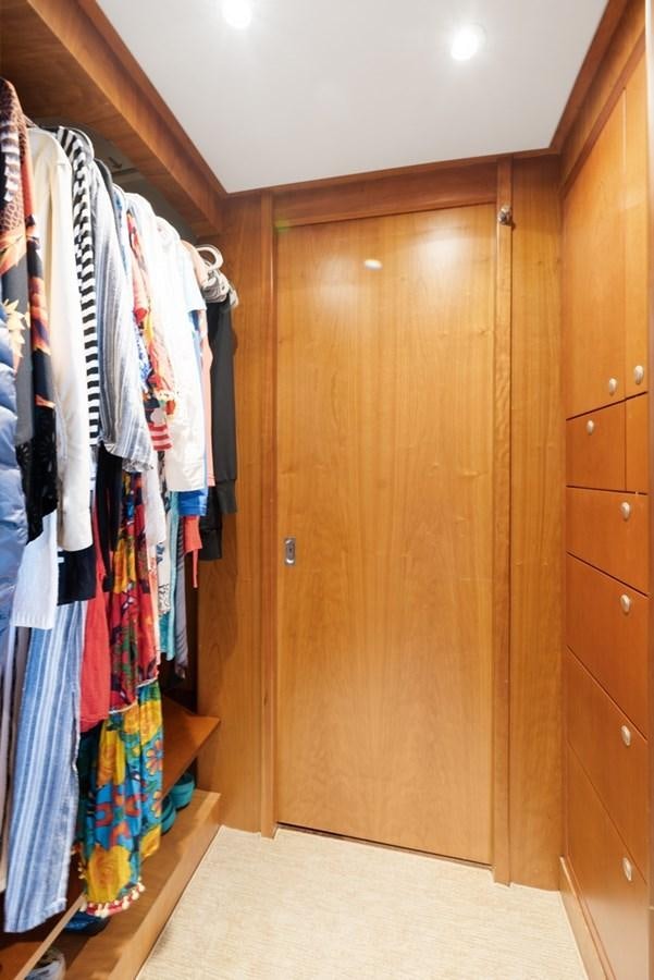 a closet with clothes on the wall aboard A.B. NORMAL Yacht for Sale