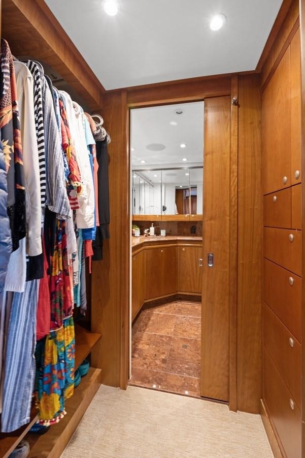 a closet with clothes on the wall aboard A.B. NORMAL Yacht for Sale