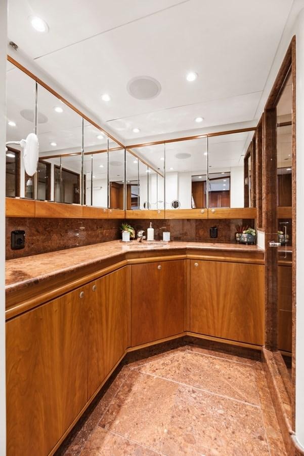 a kitchen with wooden cabinets aboard A.B. NORMAL Yacht for Sale