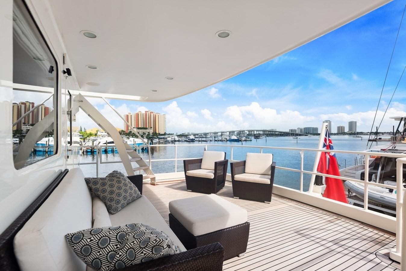 a boat with a large deck and chairs on the deck aboard A.B. NORMAL Yacht for Sale