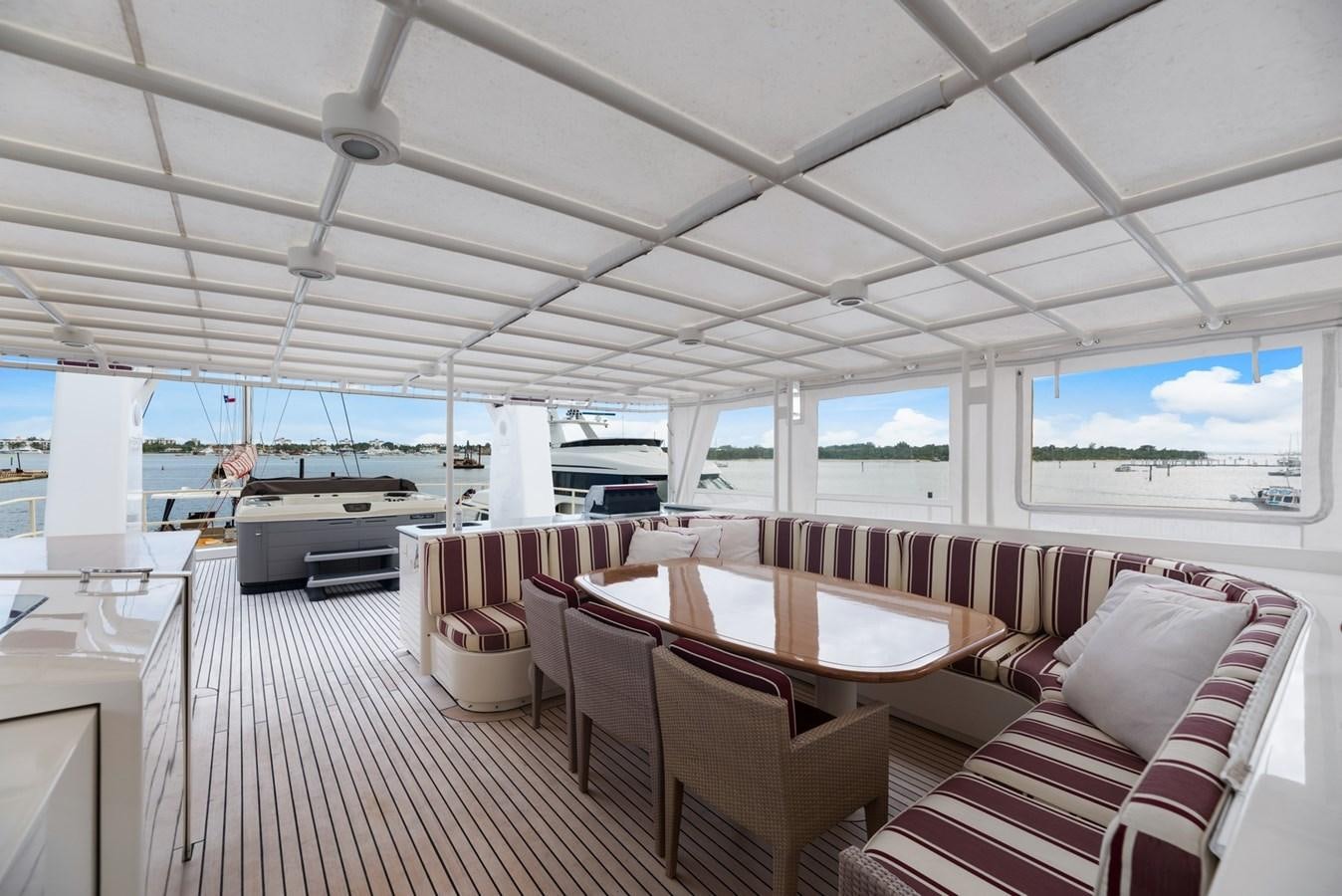 a room with a table chairs and a large window aboard A.B. NORMAL Yacht for Sale