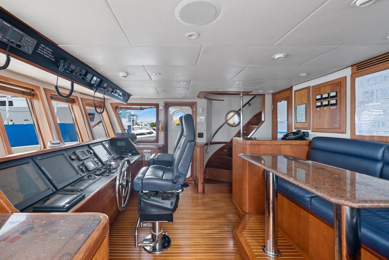 a room with a table and chairs aboard A.B. NORMAL Yacht for Sale