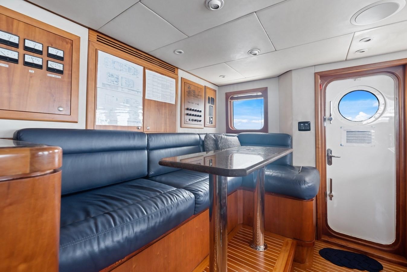 a room with a couch and a table aboard A.B. NORMAL Yacht for Sale