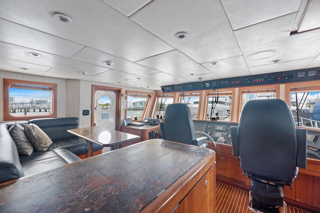 inside of a vehicle with a table and chairs aboard A.B. NORMAL Yacht for Sale