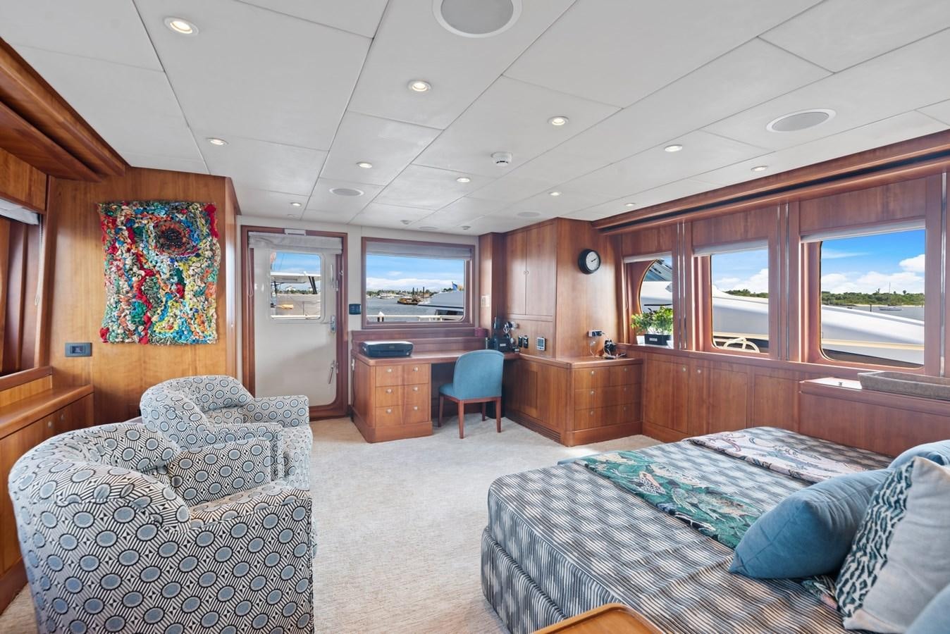 a bedroom with a bed and a chair aboard A.B. NORMAL Yacht for Sale