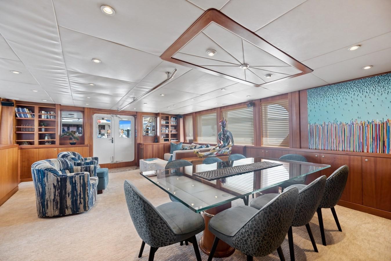 a room with a table chairs and a large window aboard A.B. NORMAL Yacht for Sale