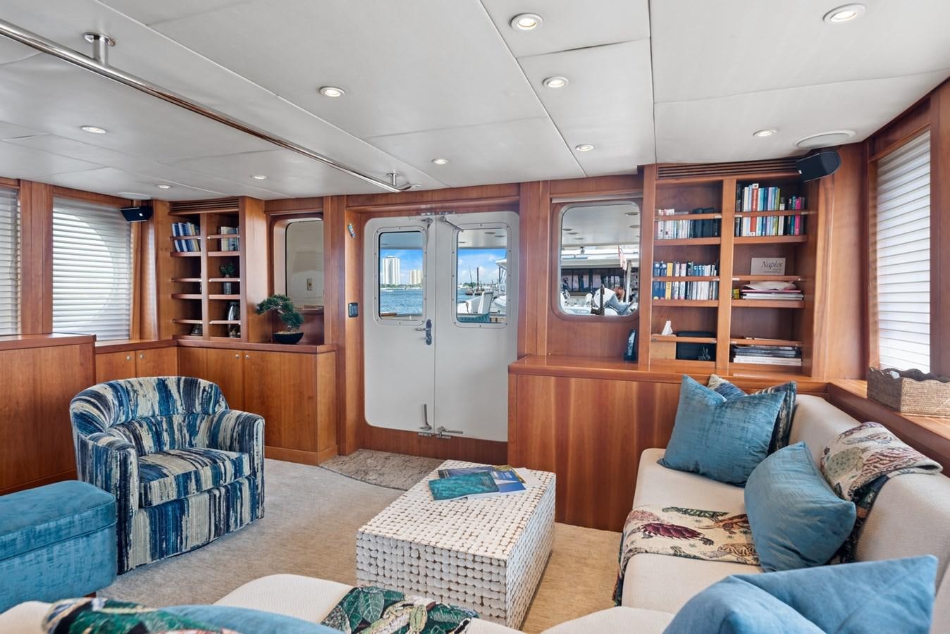 a living room with a couch and a bookcase aboard A.B. NORMAL Yacht for Sale