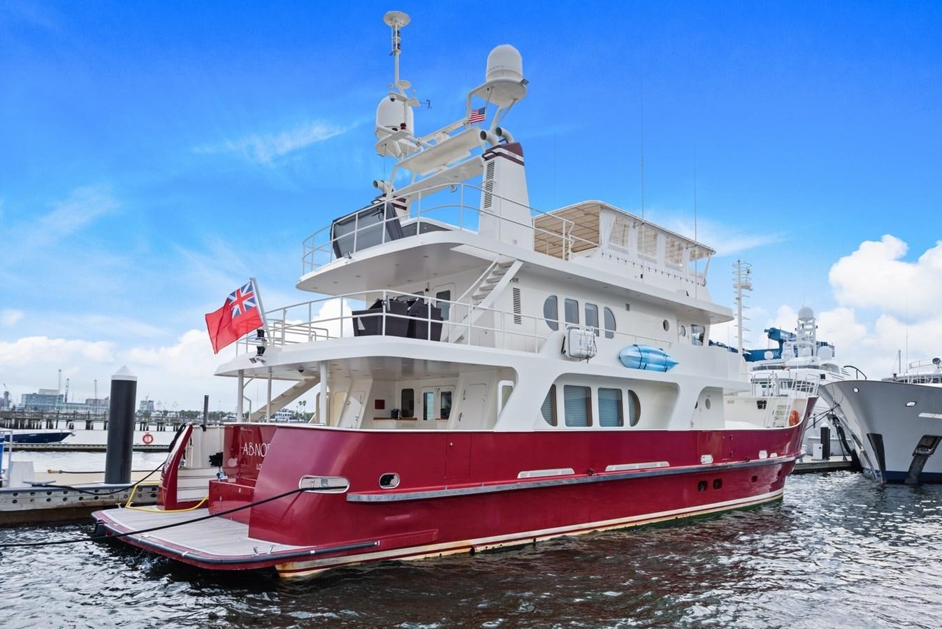a large boat docked at a pier aboard A.B. NORMAL Yacht for Sale