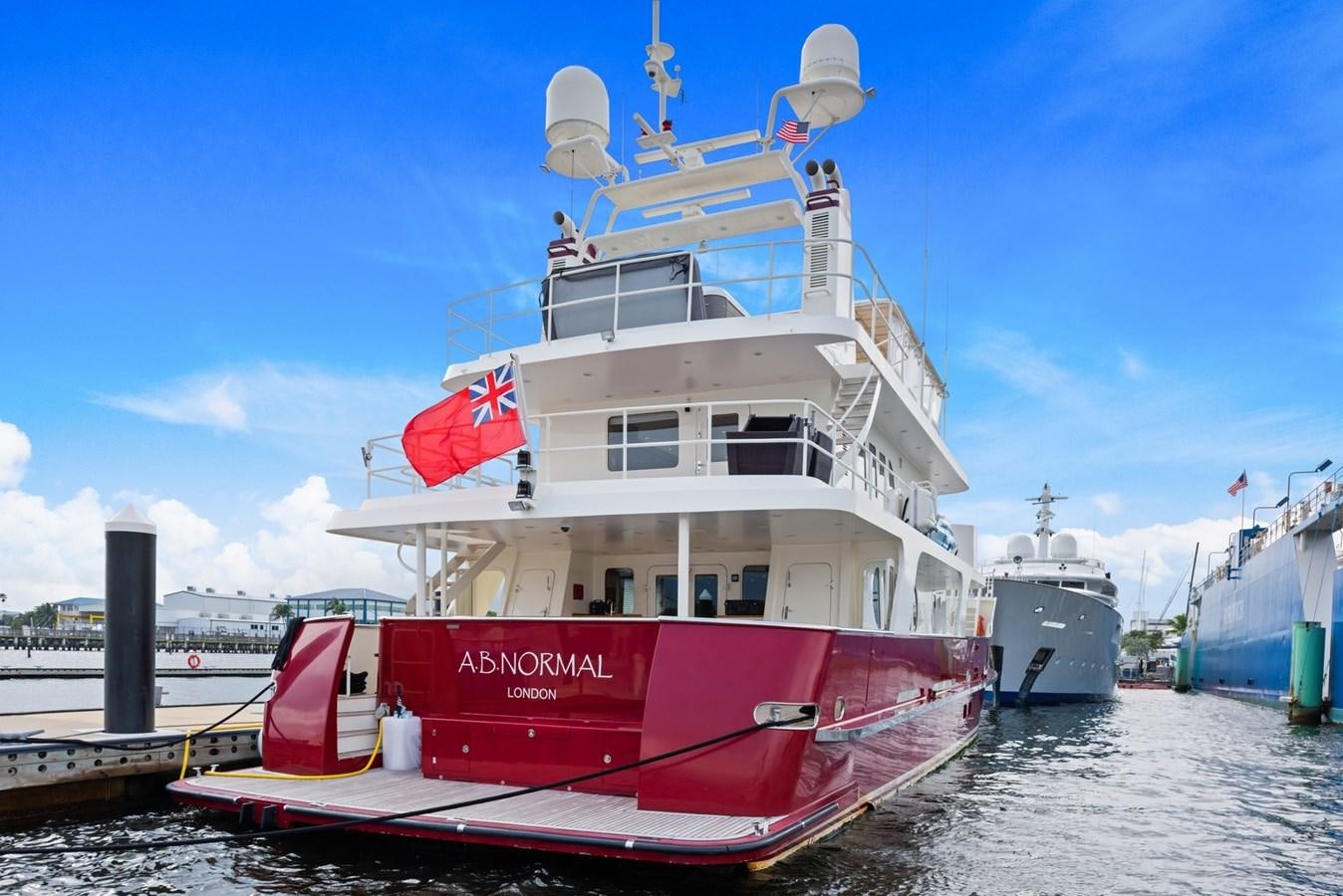 a large white boat docked at a pier aboard A.B. NORMAL Yacht for Sale