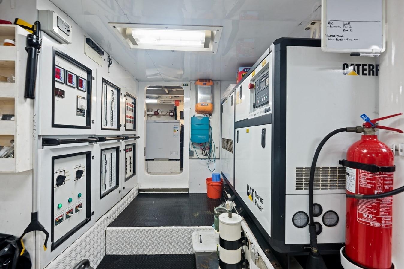 a room with machines and a red fire extinguisher aboard A.B. NORMAL Yacht for Sale