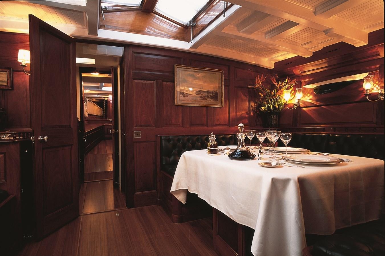 a table set with wine glasses aboard MOONBEAM OF FIFE III Yacht for Sale