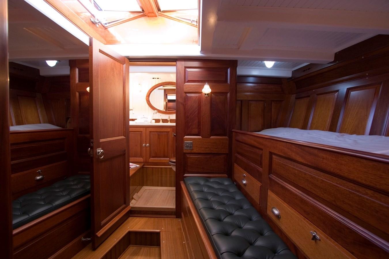 a room with a bed and a mirror aboard MOONBEAM OF FIFE III Yacht for Sale