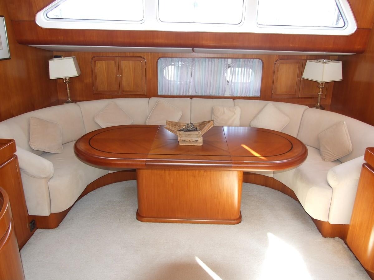 a living room with a couch and a coffee table aboard IMPRESSION Yacht for Sale