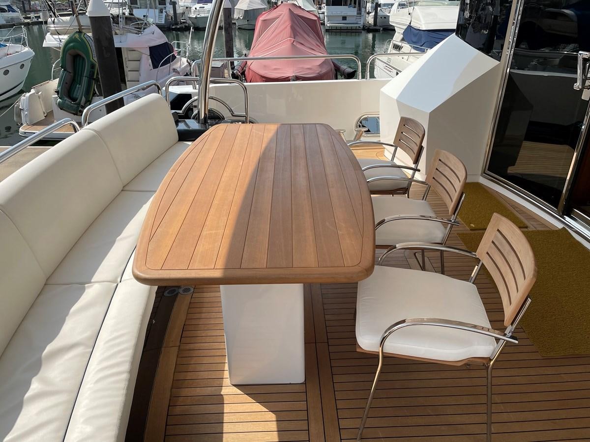 a table with chairs around it aboard SUNSEEKER 30M Yacht for Sale