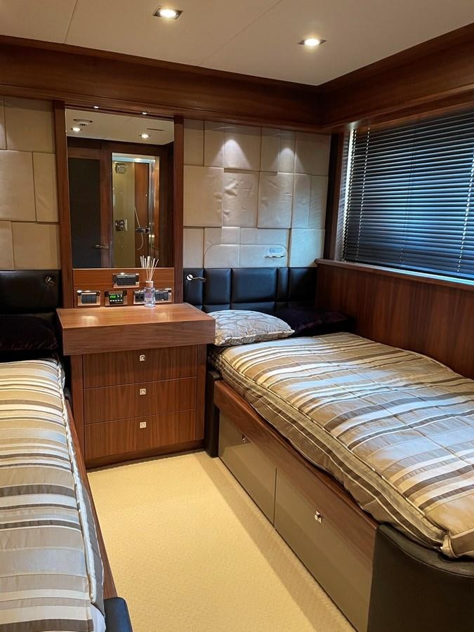 a bedroom with two beds aboard SUNSEEKER 30M Yacht for Sale
