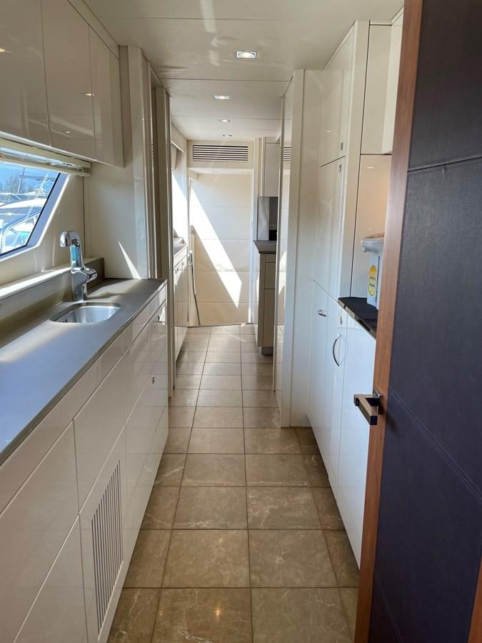 a kitchen with a blue counter aboard SUNSEEKER 30M Yacht for Sale