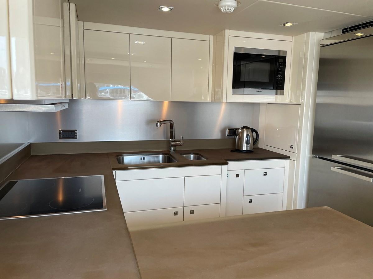 a kitchen with white cabinets aboard SUNSEEKER 30M Yacht for Sale