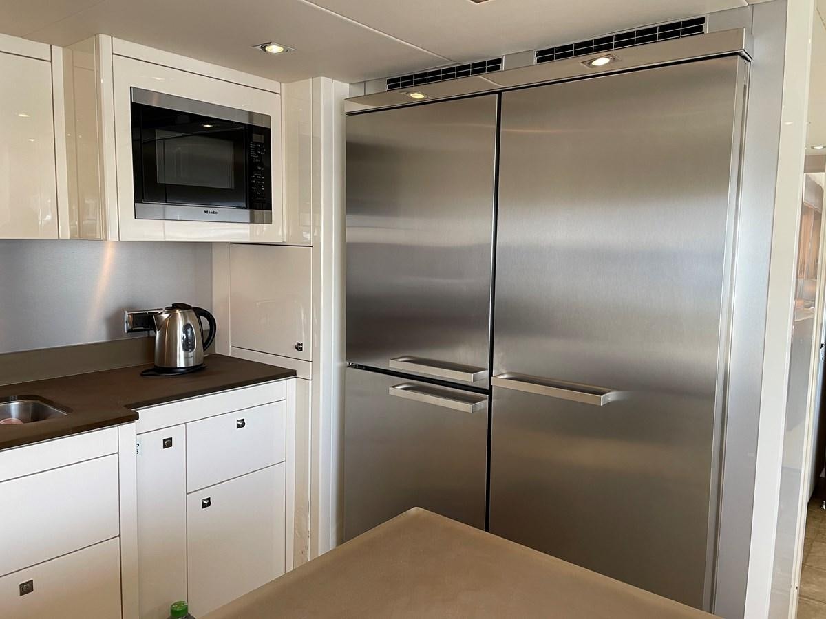 a kitchen with a stainless steel refrigerator aboard SUNSEEKER 30M Yacht for Sale