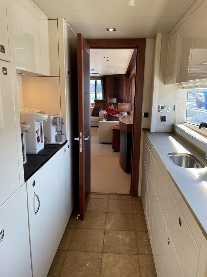 a kitchen with a sink and a door aboard SUNSEEKER 30M Yacht for Sale