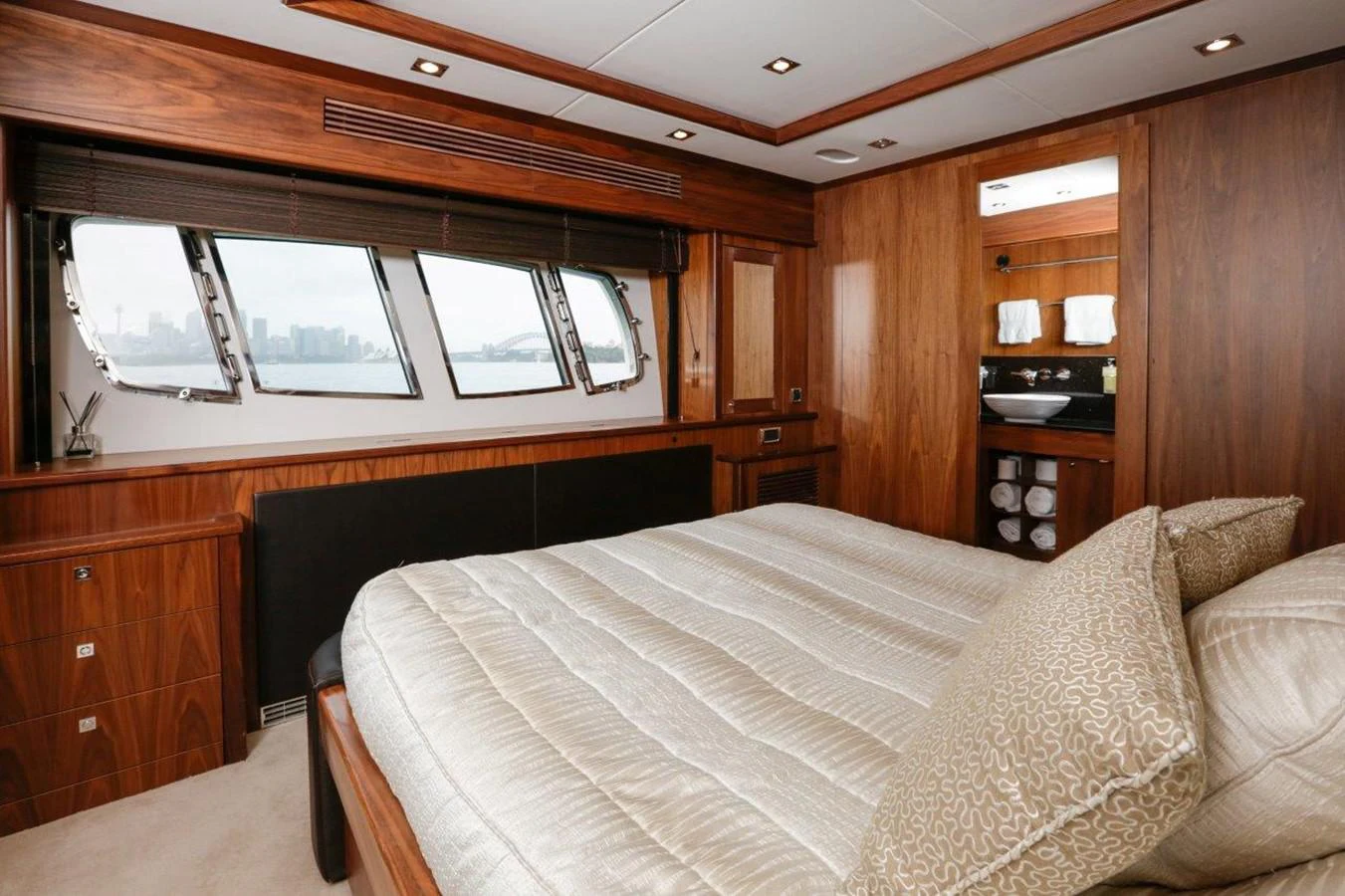 a bedroom with a bed and a window aboard COLETTE Yacht for Sale