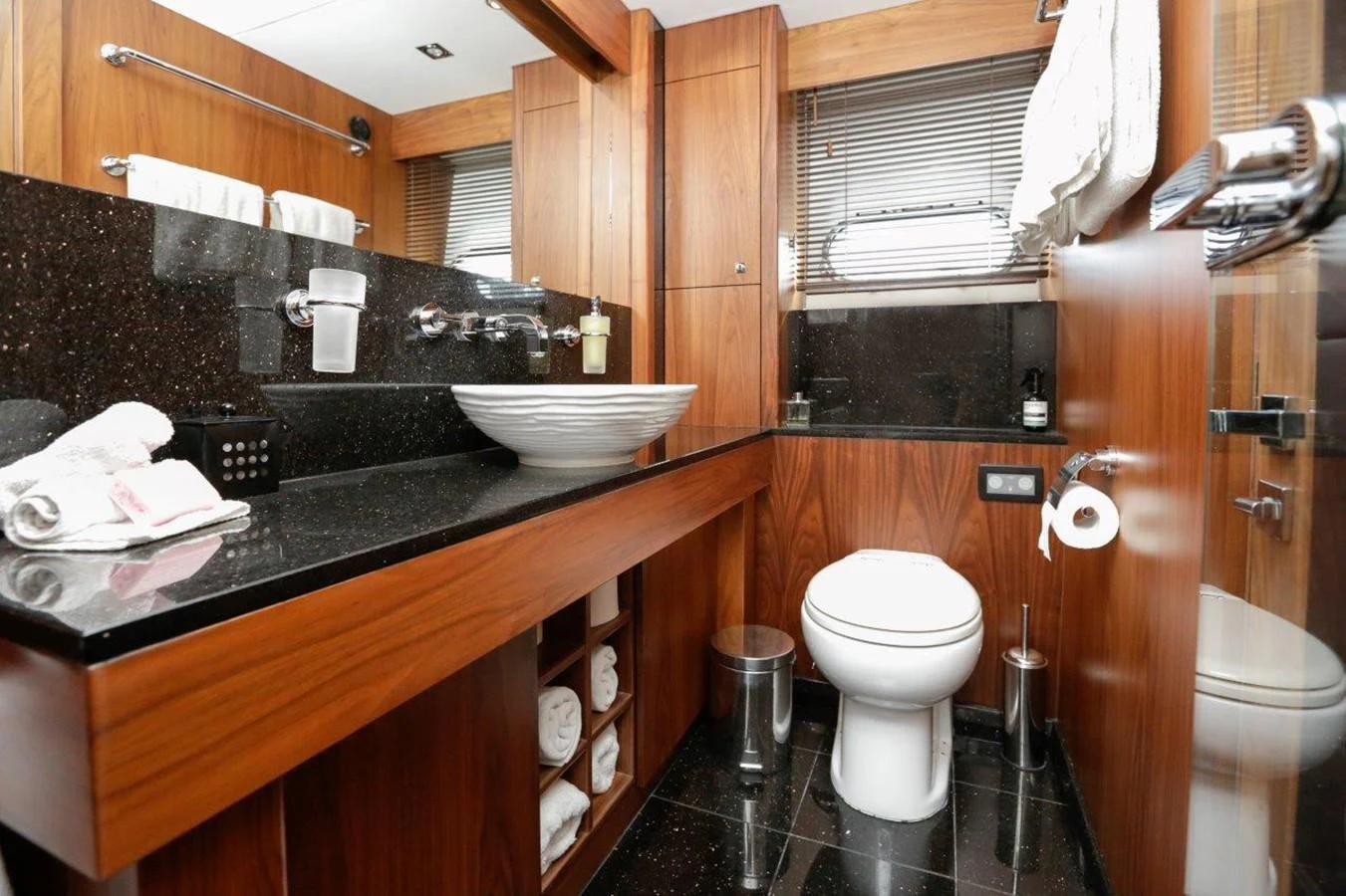 a bathroom with a sink toilet and a mirror aboard COLETTE Yacht for Sale