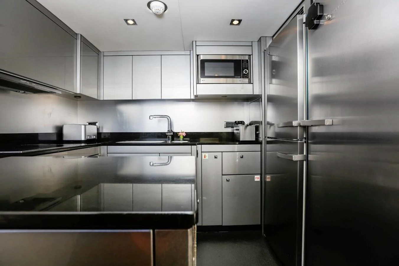 a kitchen with a refrigerator and sink aboard COLETTE Yacht for Sale