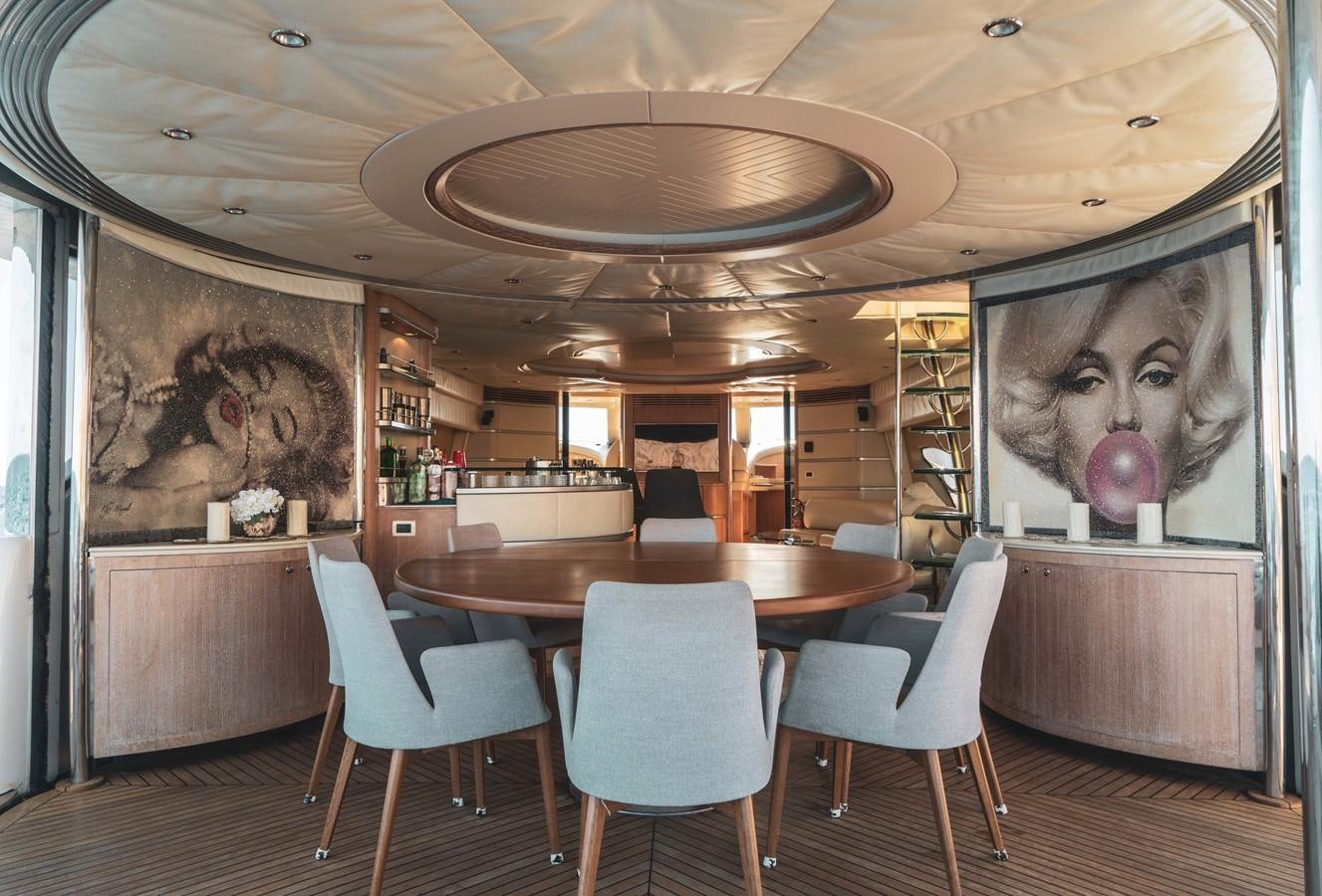 a dining room with a large painting aboard GANESH A Yacht for Sale