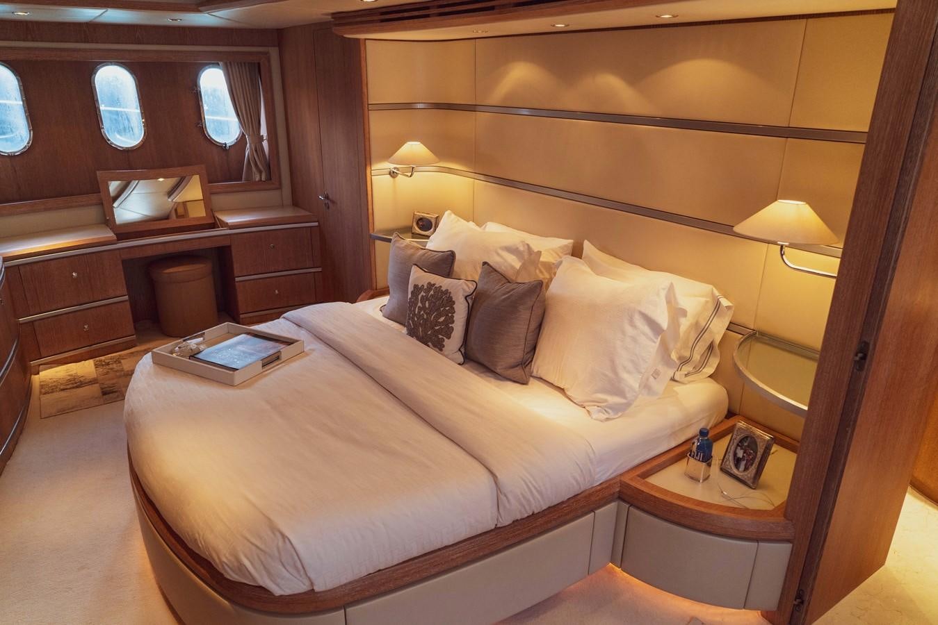 a bed with a white comforter aboard GANESH A Yacht for Sale