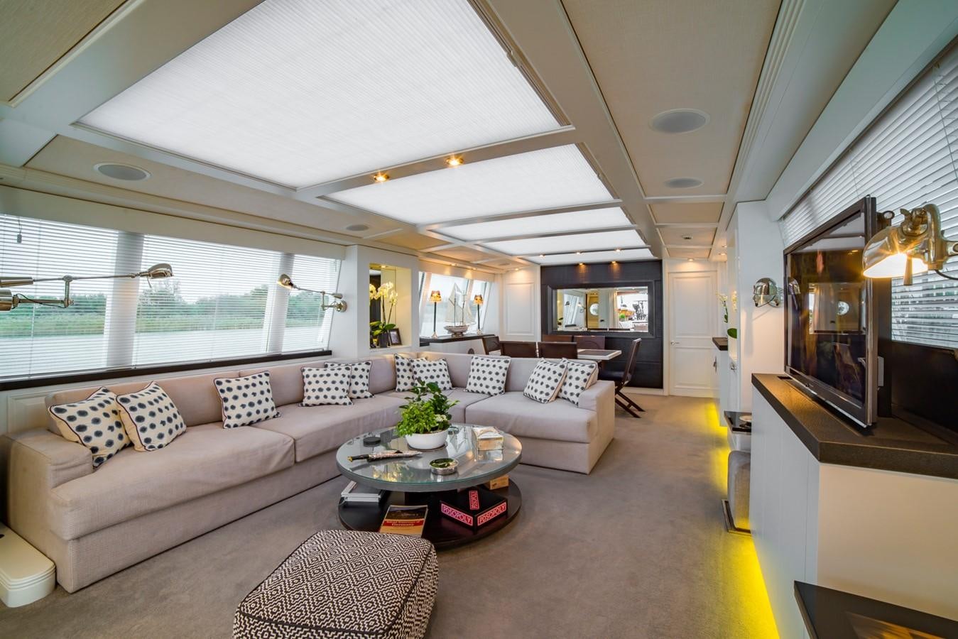 a living room with a large window aboard BARGE SAVVY Yacht for Sale