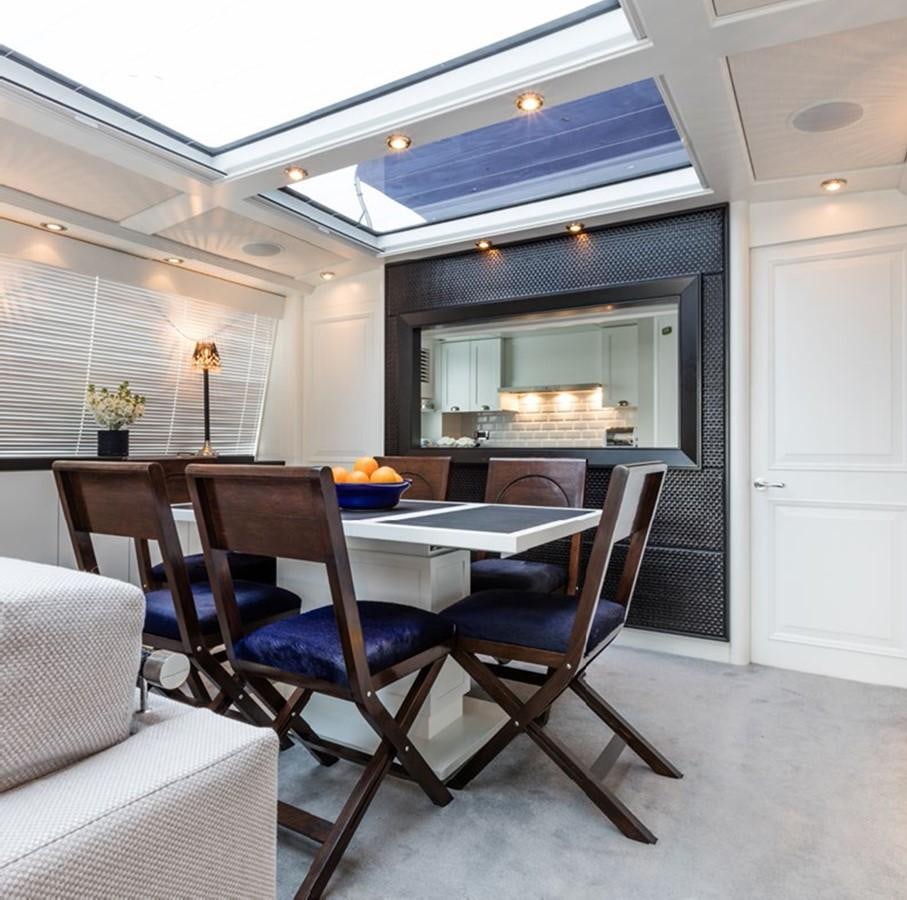 a dining room with a table and chairs aboard BARGE SAVVY Yacht for Sale