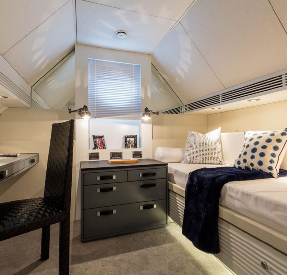 a small bedroom with a bed and a chair aboard BARGE SAVVY Yacht for Sale