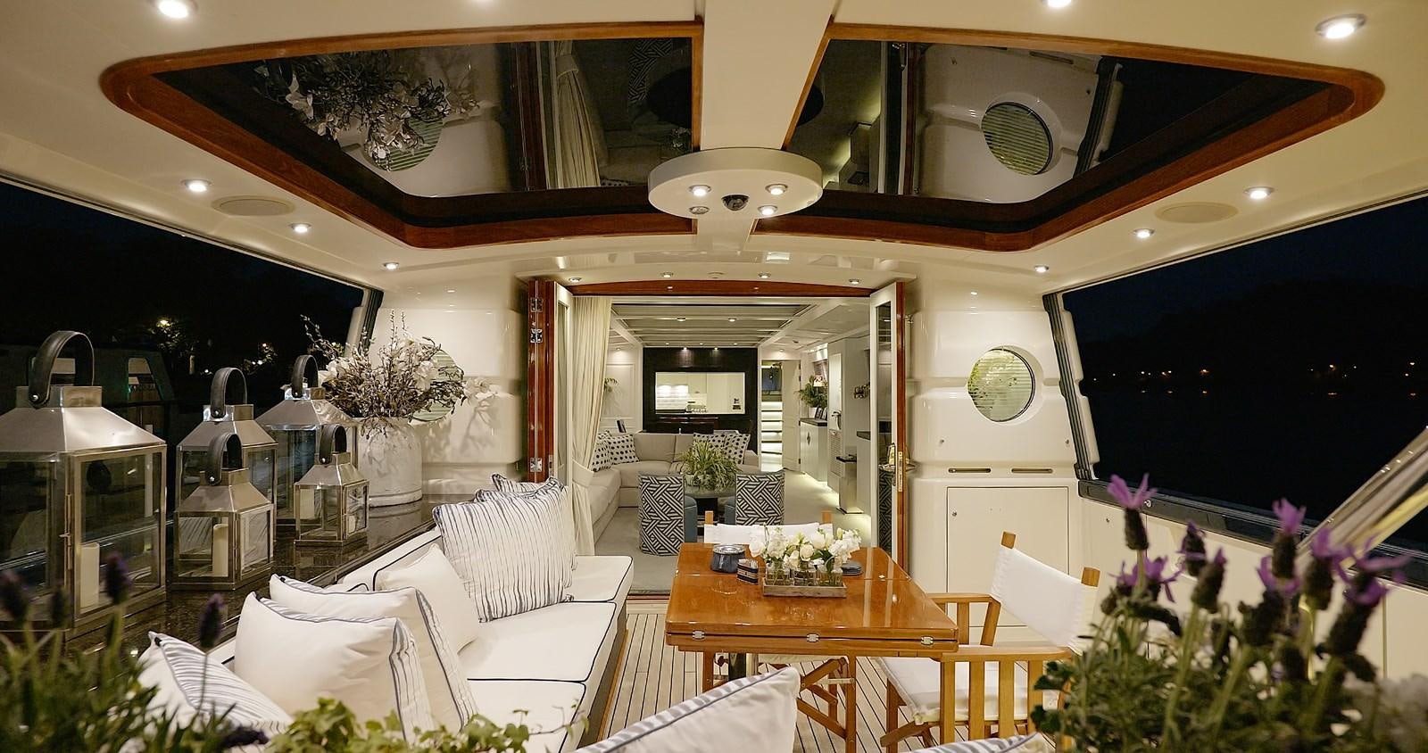 a living room with a table and chairs aboard BARGE SAVVY Yacht for Sale