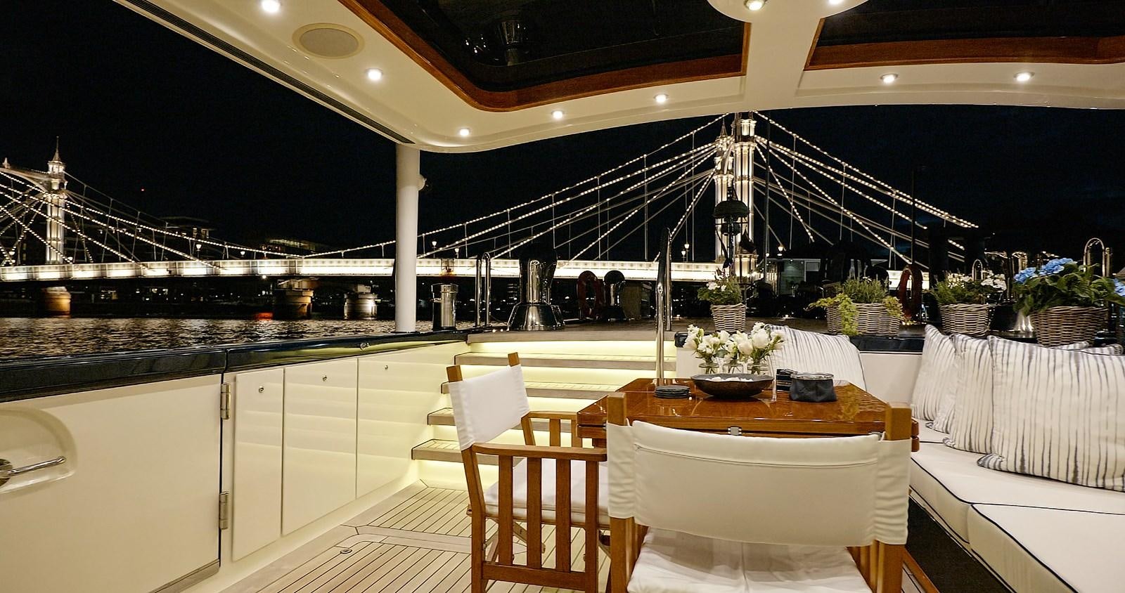 a large kitchen with tables and chairs aboard BARGE SAVVY Yacht for Sale