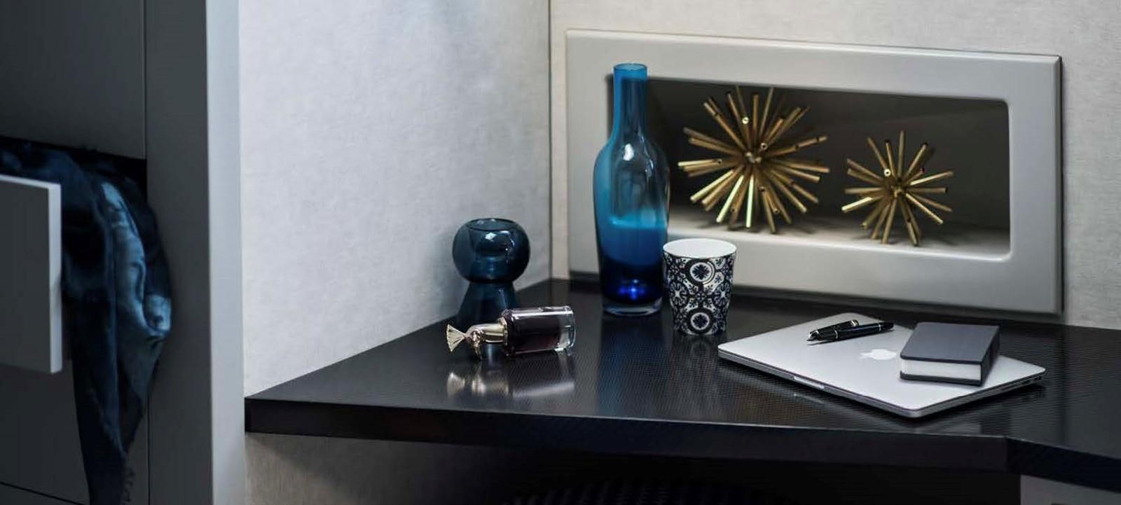 a desk with a phone and a lamp on it aboard JAMADHAR Yacht for Sale