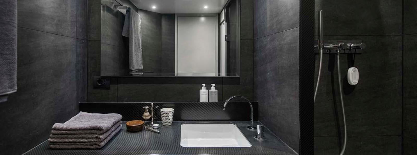 a bathroom with a large mirror aboard JAMADHAR Yacht for Sale