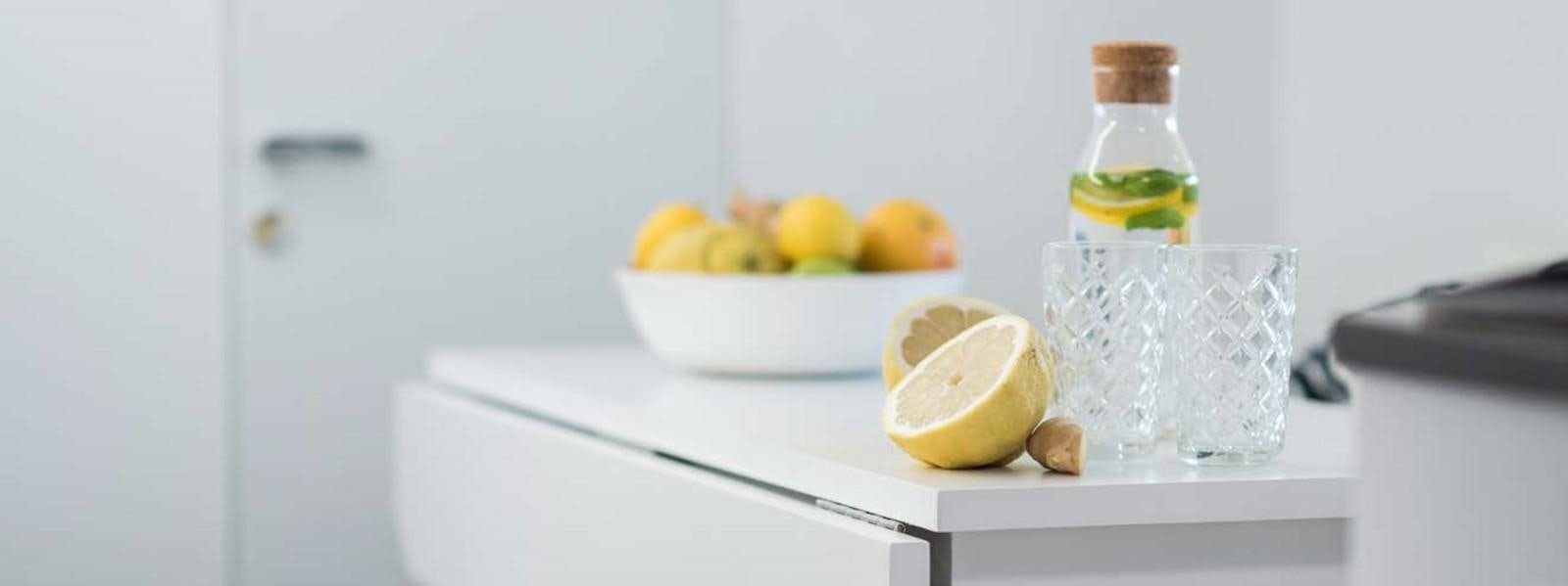 a bowl of lemons and a bottle of water on a white shelf aboard JAMADHAR Yacht for Sale