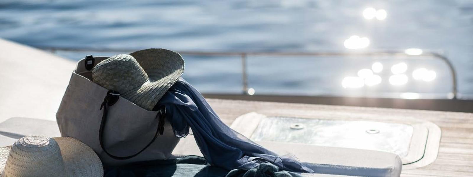 a person wearing a hat and sitting on a plane aboard JAMADHAR Yacht for Sale