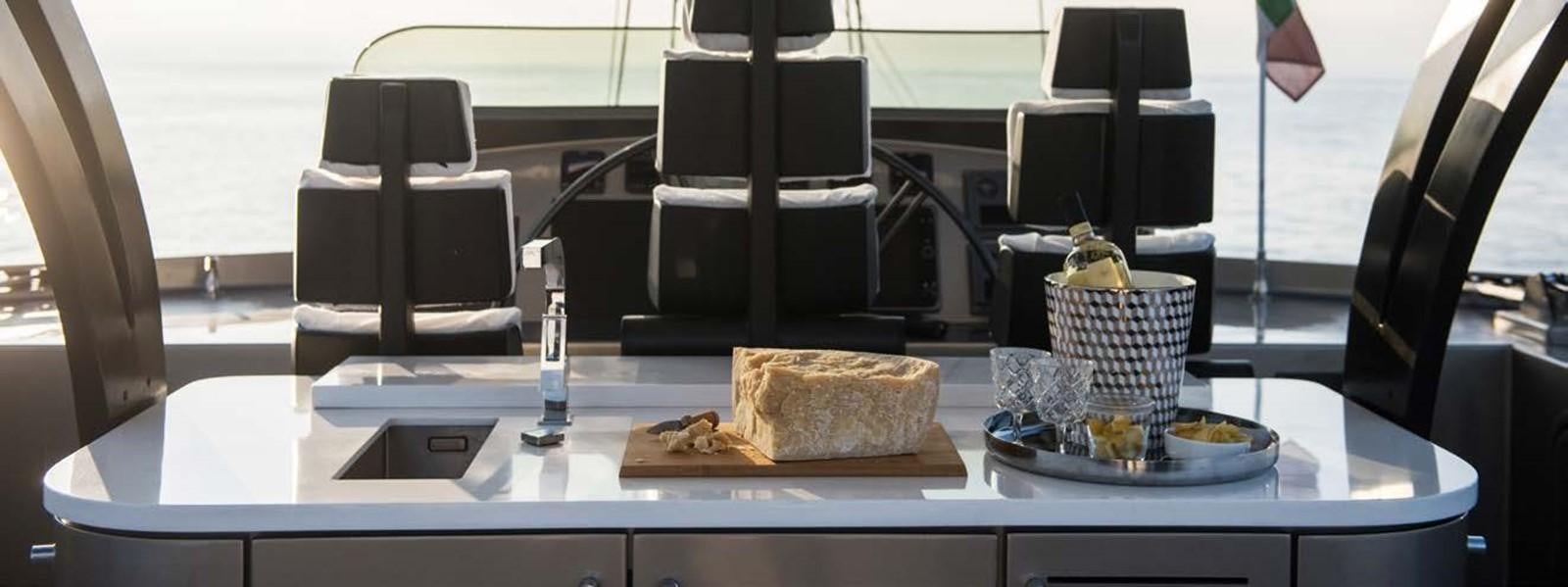 a table with food and a computer aboard JAMADHAR Yacht for Sale