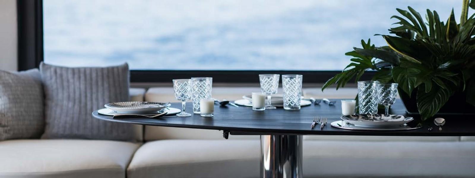 a table with a plate and glasses on it aboard JAMADHAR Yacht for Sale