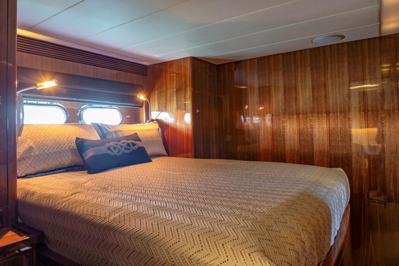 a bed with a white sheet and a blue and white pillow on it aboard SUMMER WIND Yacht for Sale