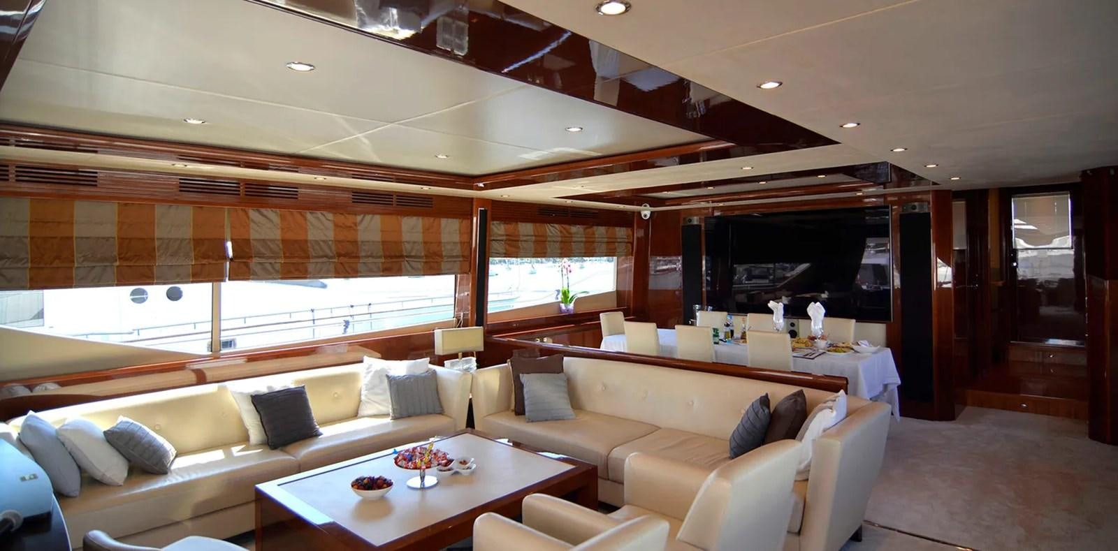 a room with couches and a table aboard PRINCESS 95 Yacht for Sale