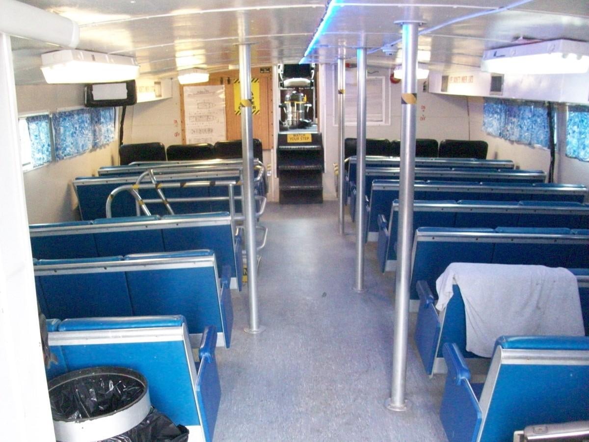 a room with rows of desks and chairs aboard NO NAME HALF MOON CLIPPER Yacht for Sale