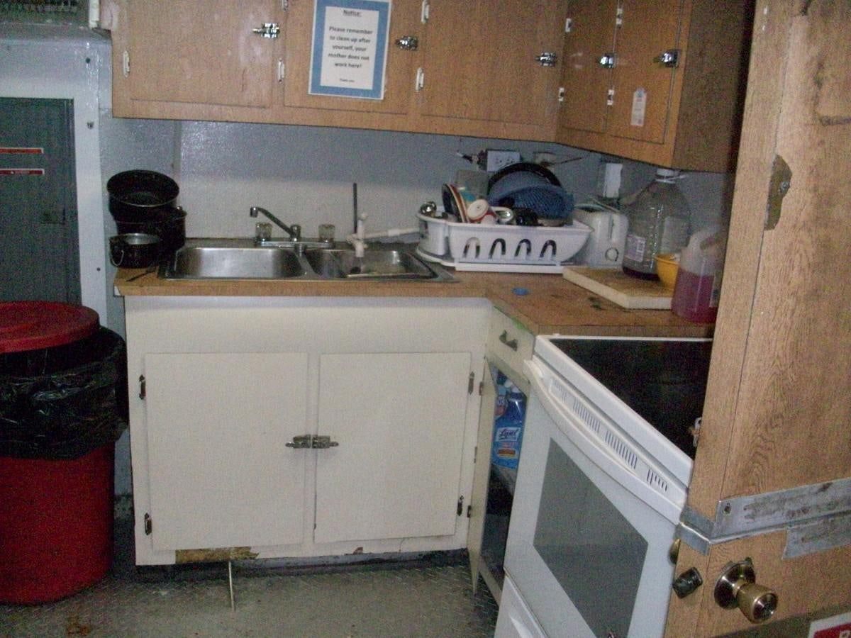 a kitchen with wooden cabinets aboard NO NAME HALF MOON CLIPPER Yacht for Sale