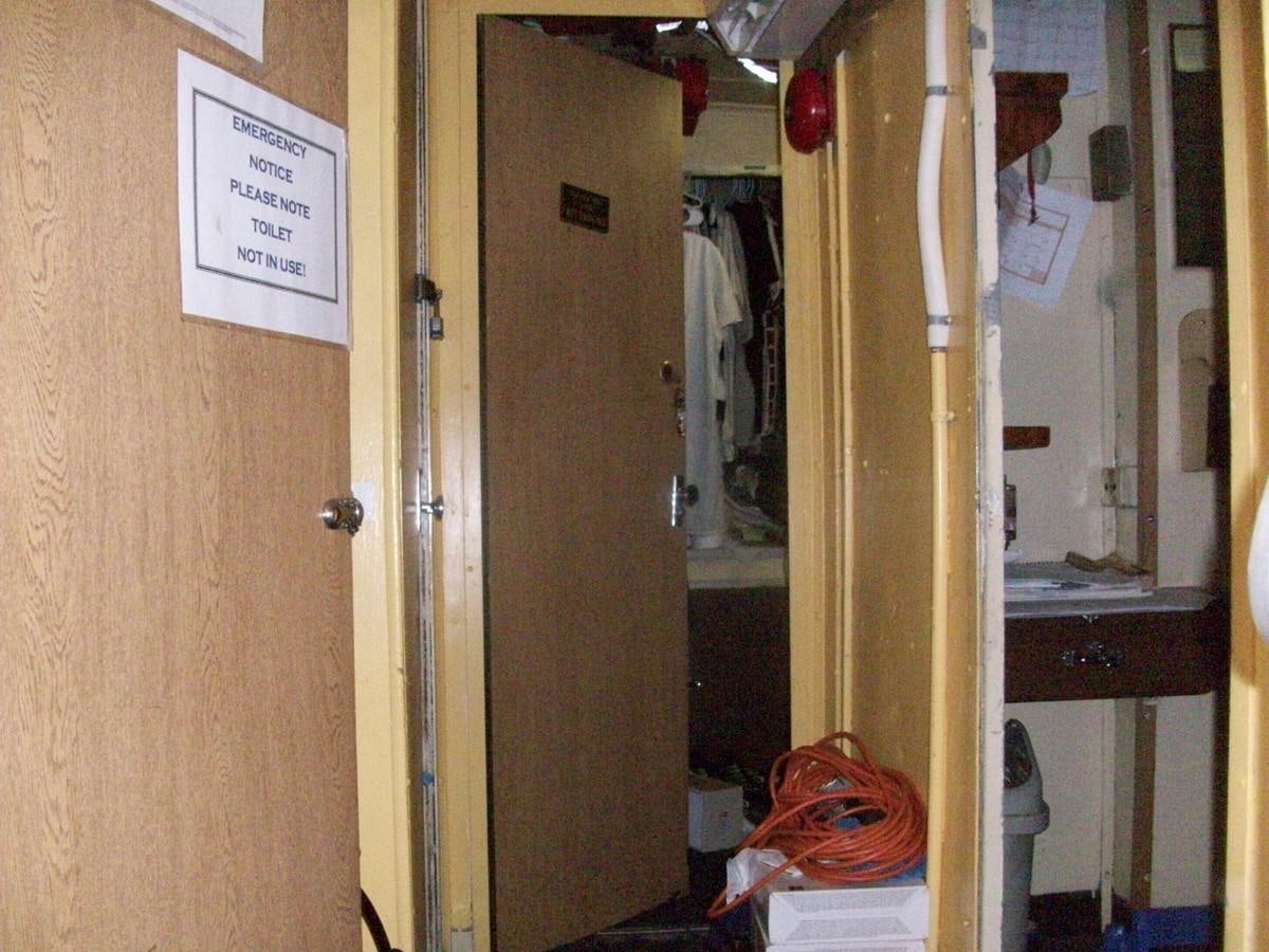 a room with a door and a sign on the wall aboard NO NAME HALF MOON CLIPPER Yacht for Sale