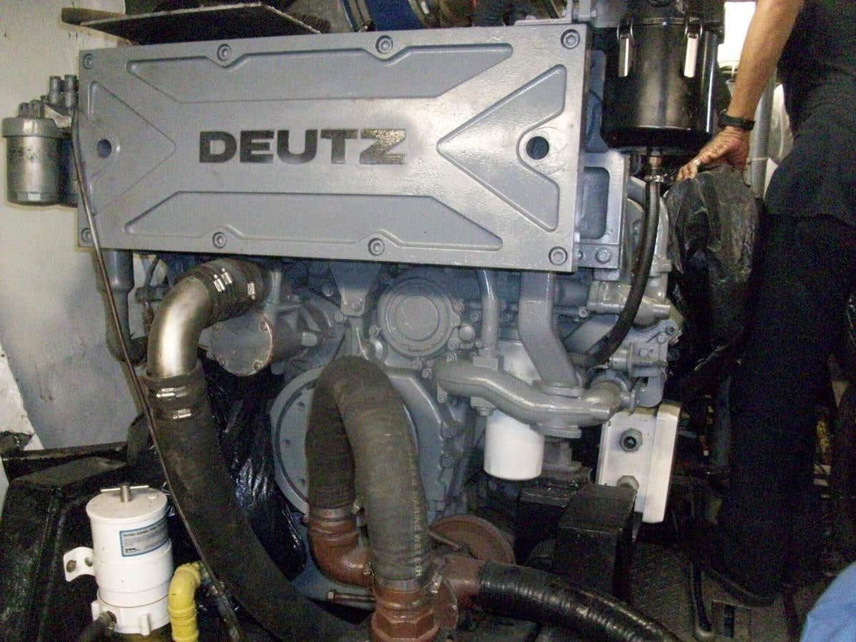 a car engine with a person standing next to it aboard NO NAME HALF MOON CLIPPER Yacht for Sale