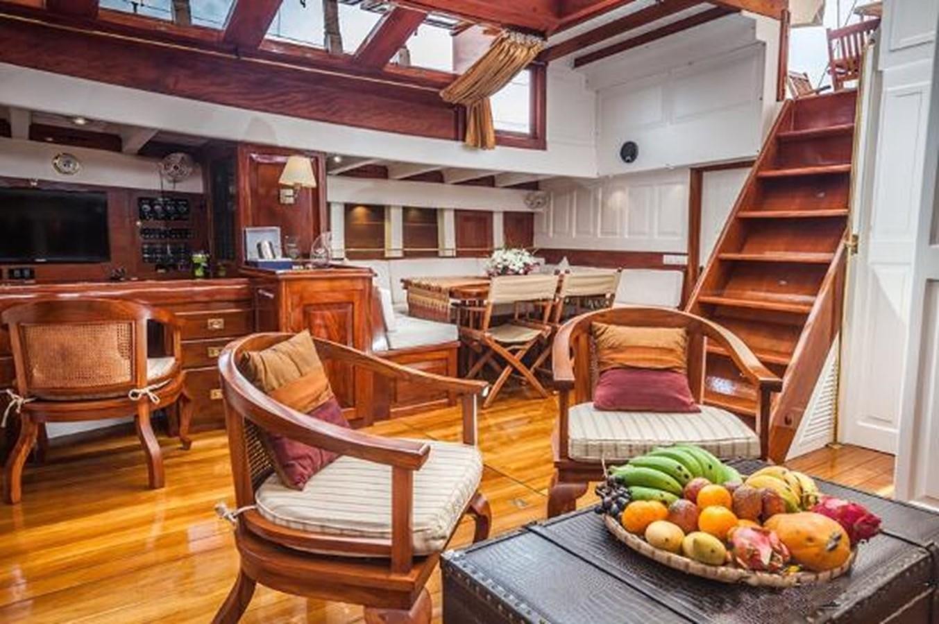 a kitchen with a table and chairs aboard 95FT 2011 CUSTOM KETCH CLASSIC YACHT Yacht for Sale